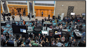KubeCon attendees gather around exhibitor booths at the conference